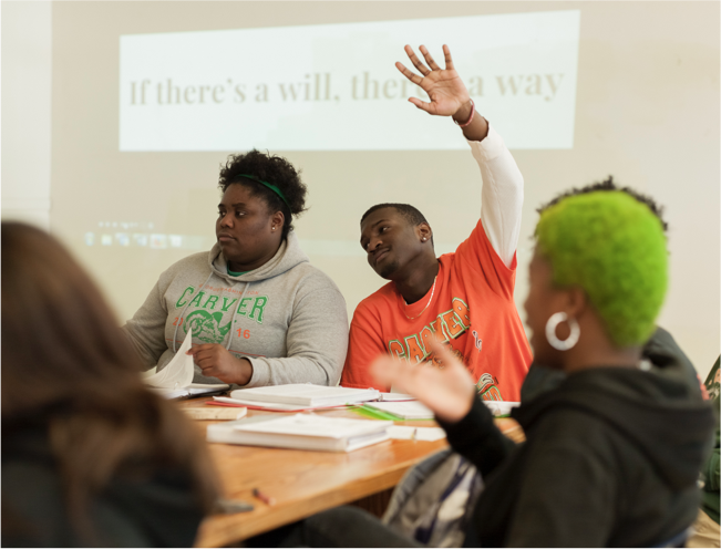 Photo of student raising hand in class