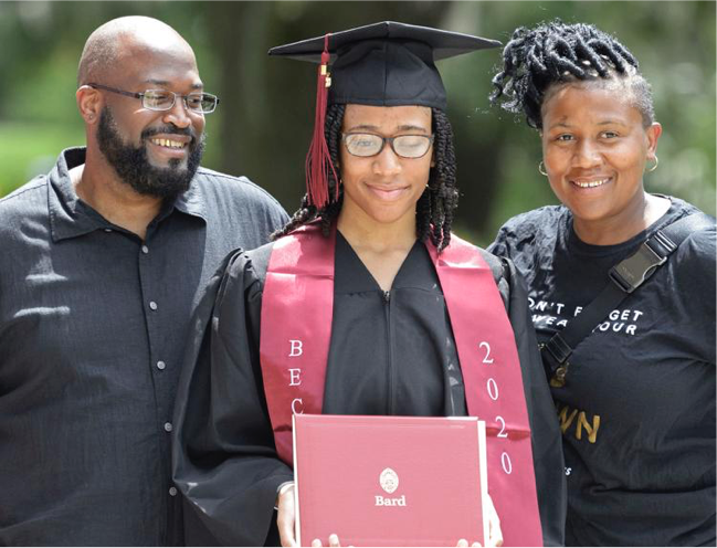 Student and family smiling on graduation day