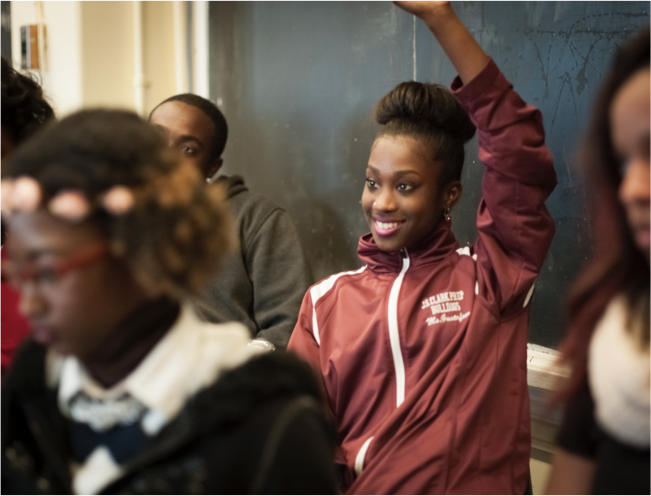 Student raising her hand in class